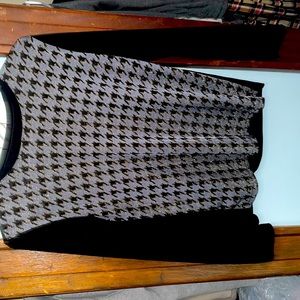 Neat looking top. Machine washable. Goes well with jeans. Has no tags or labels.